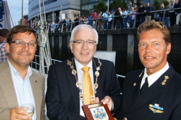 Honorary Consul for the Netherlands Carson Mc Mullan looks on as the Mayor of Lisburn City, Councillor Allan Ewart, presents Commanding Officer Ferry van Schoonhoven with the Lisburn City crest to mark the occasion of the Urania's visit to Northern Ireland.